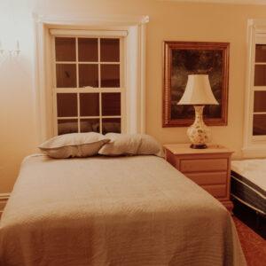 Bedroom and furnishings inside the restoration home project by Greenlight Operation